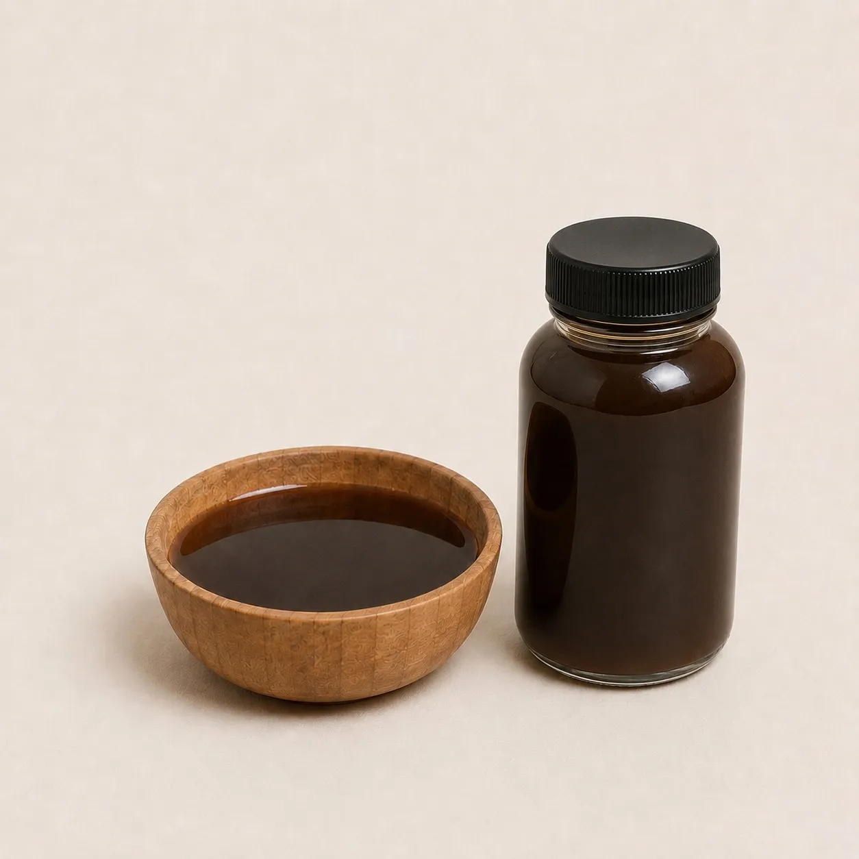 Liquid coconut sugar syrup in a bowl and a glass bottle